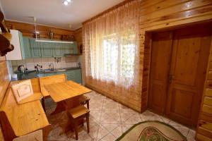 a kitchen with a wooden table and a sink at Елізабет 1 in Svityazʼ