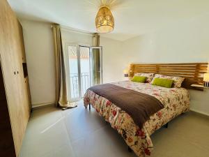 a bedroom with a bed and a large window at La casa del pinsapo in Yunquera +30 photos