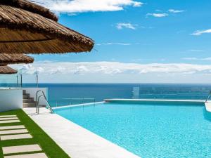 a swimming pool with a view of the ocean at Bayview Hills Apartamento Andaluz in Torrox