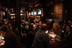 a group of people sitting at tables in a restaurant at The Bartlett Hotel and Guesthouse in San Francisco