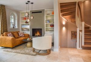 a living room with a couch and a fireplace at Haus Friesenkrone in Braderup