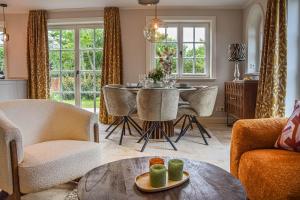 a living room with a table and chairs at Haus Friesenkrone in Braderup +45 photos