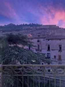 a view of a city with a building on a hill at Ellebi Galleria e Dimora D'arte in Cosenza