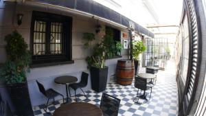 a room with chairs and tables and a room with plants at Tremo Bellavista in Santiago
