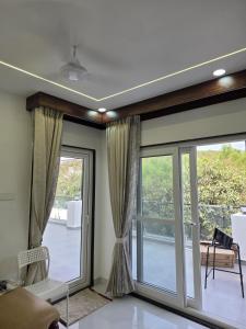 a living room with a sliding glass door at The Sanctuary by exot in Visakhapatnam