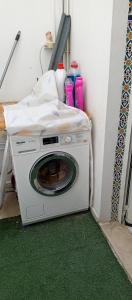 a washing machine sitting in a corner of a room at Appartement terrasse climatisée in Tunis