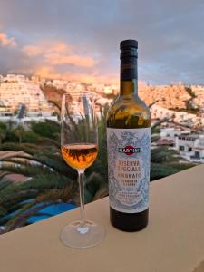 a bottle of wine sitting next to a wine glass at Veiw Luxury Apartment in Adeje