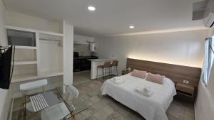 a hotel room with a bed and a kitchen at Aparts Magallanes in Pilar