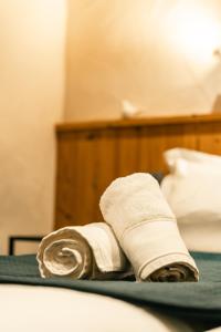 a pile of rolled towels sitting on a bed at Le Cosy - Appartement in Les Gets +19 photos