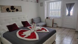 a bedroom with a bed with a flower on it at APARTMA SEA VIEW in Portorož