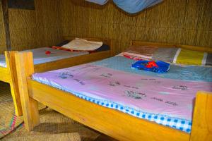 two twin beds in a room at Yasur Adventure Tree house in Isangel