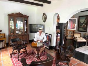 a man sitting at a table in a living room at Private room in the Heart of Little Havana for 4 Guests in Miami