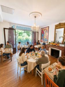 a group of people sitting at tables in a restaurant at Hôtel Des Poètes avec parking sur réservation in Béziers