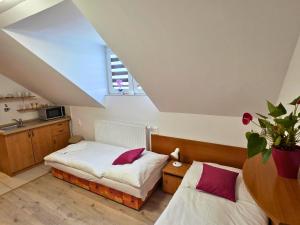 a bedroom with two beds and a window at Ubytovanie LISKA in Radava
