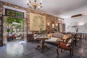 a living room with a couch and a table at Greco Hotel in Hydra