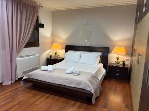 a bedroom with a bed with towels on it at Casa Maria Tsampika-Spacious Home with 2 Bathrooms & Free Parking in Psinthos