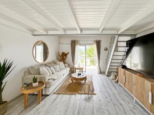 a living room with a couch and a table at Duplex La Plage Orient Bay in Orient Bay