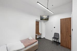 a bedroom with a bed and a desk and a chair at ZDZ Hostel Królewska 15 in Lublin