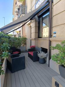 a patio with couches and plants on a building at Hotel La Nuova Rotaia in Gallarate