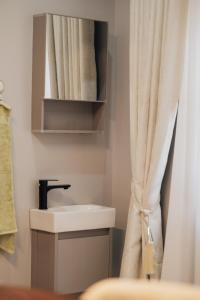 a bathroom with a sink and a shower curtain at Smart Luxury Apartment, Bunga in Kampala +20 photos