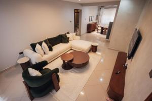 a living room with a couch and chairs and a table at Smart Luxury Apartment, Bunga in Kampala