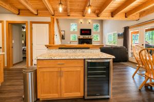 a kitchen with wooden cabinets and a counter top at Compass Cabin by NW Comfy Cabins in Leavenworth +59 photos