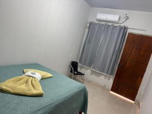 a bedroom with a bed and a dresser and a window at Hotel Colinas in Cajuapara