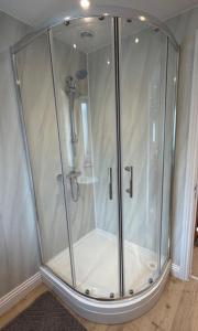 a shower with a glass enclosure in a room at Pendragon Studio in Penzance +7 photos