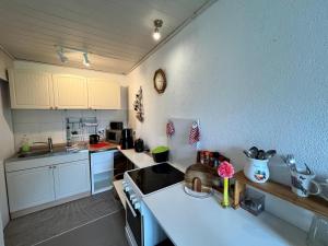 a kitchen with white cabinets and a counter top at Gemütlicher Bungalow in Pepelow nahe dem Meer in Pepelow