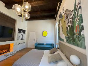 a bedroom with a bed and a tv and a fireplace at Ellebi Galleria e Dimora D'arte in Cosenza