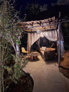 a pergola with a bed and a couch under it at loft B in Fez