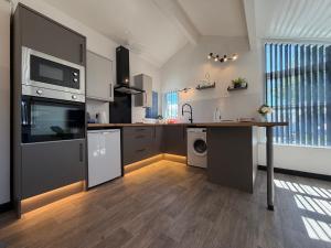 a kitchen with a table and a counter top at Glowstay 2 in Lampeter +6 photos