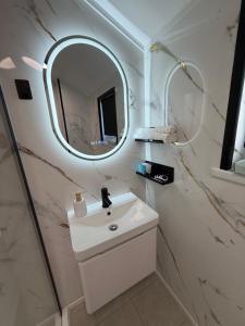a bathroom with a white sink and a mirror at Glowstay 2 in Lampeter