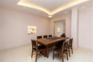 a dining room with a wooden table and chairs at El Agamy Hotel Apartment in Luxor