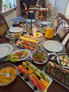 a table with plates of food on top at Pensjonat Krystyna in Rewa