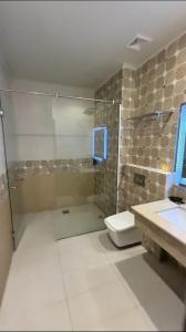 a bathroom with a shower and a toilet and a sink at JAANI's Hotel in Bhattiawāla