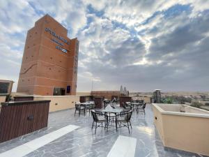 a rooftop patio with tables and chairs on a building at Pyramids Sunshine View in Giza