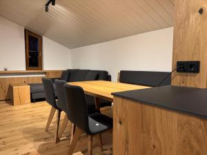 a conference room with a wooden table and chairs at Appartements Lenzikopf in Brand