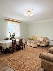 a living room with a table and a couch at MARY in Stepʼanavan