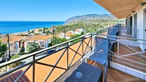 a balcony with a view of the ocean at Sandy Bay Hotel in Plomari