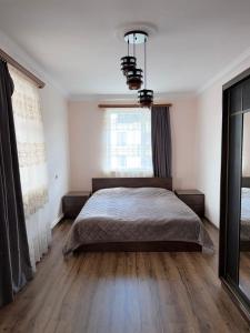a bedroom with a bed and a large window at MARY in Stepʼanavan