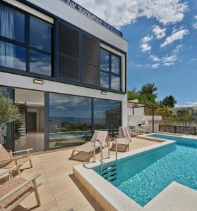 an image of a house with a swimming pool at NS Luxury Villas in Podstrana