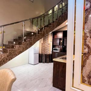 a kitchen with a staircase in a house at فلل أرياف - Aryaf in Abha