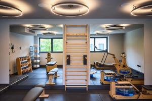 a gym with treadmills and exercise equipment at nōa Schladming in Schladming