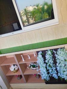 a balcony with two potted plants and a window at The hidden oasis, steps from the beach and pool in Mohammedia