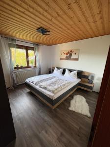 a bedroom with a bed and a wooden ceiling at Ferienwohnung Maxi in Pottenstein