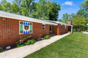 a brick house with a mural on the side of it at Nantahala Ridge in Bryson City