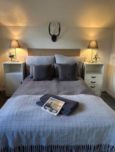 a bedroom with a bed with a book on it at Lolland Bed & Breakfast in Søllested