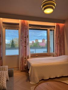 a bedroom with a bed and a large window at Opera Magic Castle View, Air-Con, Free wifi in Savonlinna