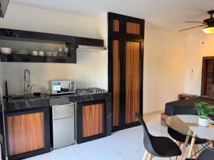 a kitchen and living room with a table and chairs at Loft with Private Terrace in Tepic